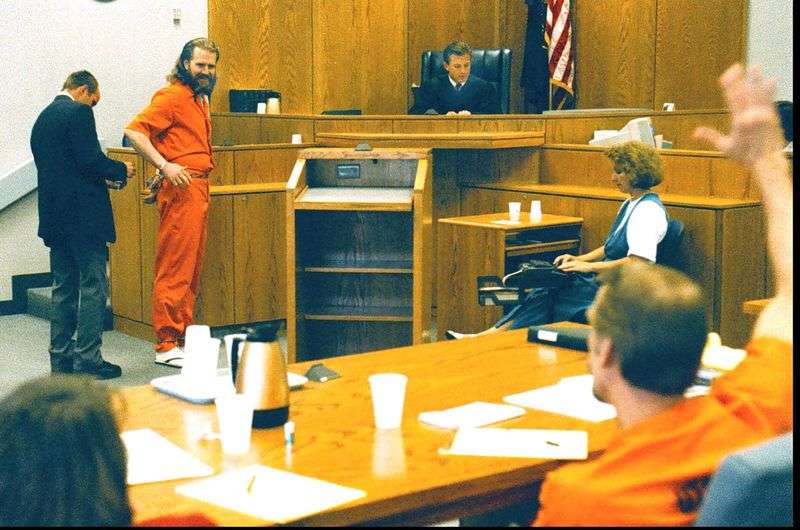 Dan Lafferty smiles at brother Ron as Ron waves to Dan
in the mid-1990s. The Laffertys had not seen each other for 11
years after being convicted in 1985 for the murder of their
sister-in-law and baby niece.