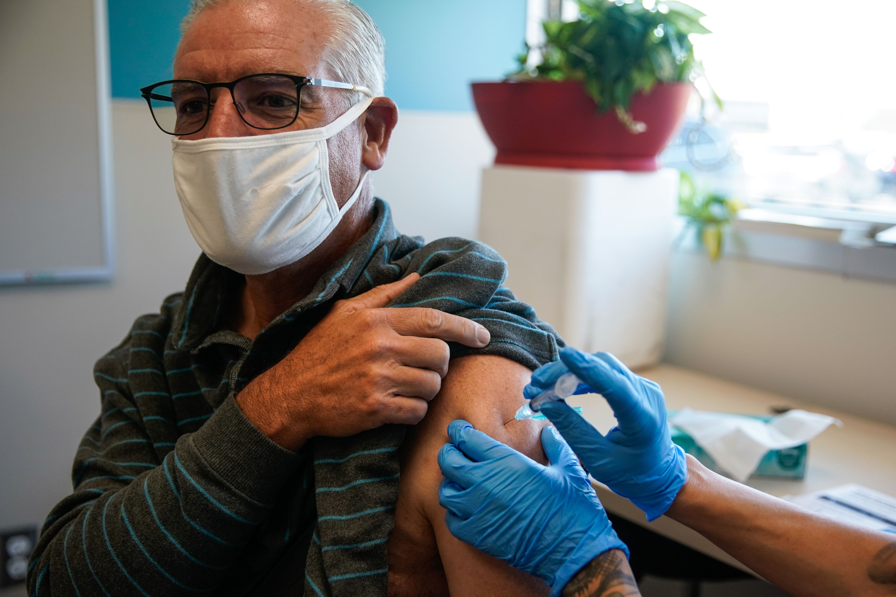 Salt Lake City resident Kim Irwin Pack receives an influenza vaccine on Sept. 30. As the U.S. Department of Health and Human Services announced Tuesday COVID-19 vaccines may have helped prevent 200 deaths among older adults in Utah during the first five months of this year, doctors at University of Utah Health urged those over age 65 to get a booster shot.