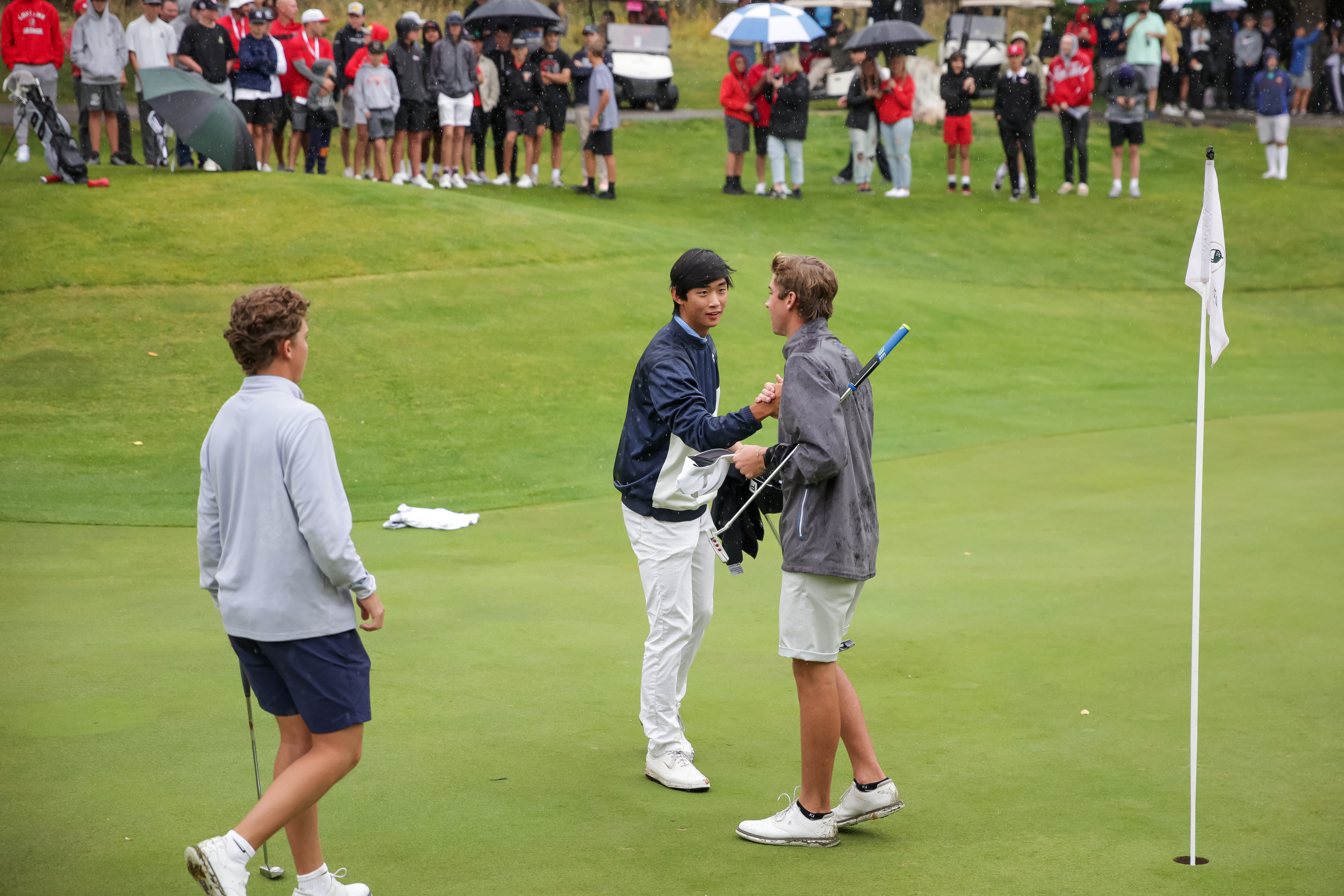 Woods Cross' Rex Poulsen, Skyline's Peter Kim and Spanish Fork's Jackson Rhees congratulate each other at the end of their second round in the 5A boys state golf tournament at The Oaks at Spanish Fork in Spanish Fork on Tuesday, Oct. 5, 2021. Kim and his teammates at Skyline took the team title while Rhees took the individual title.