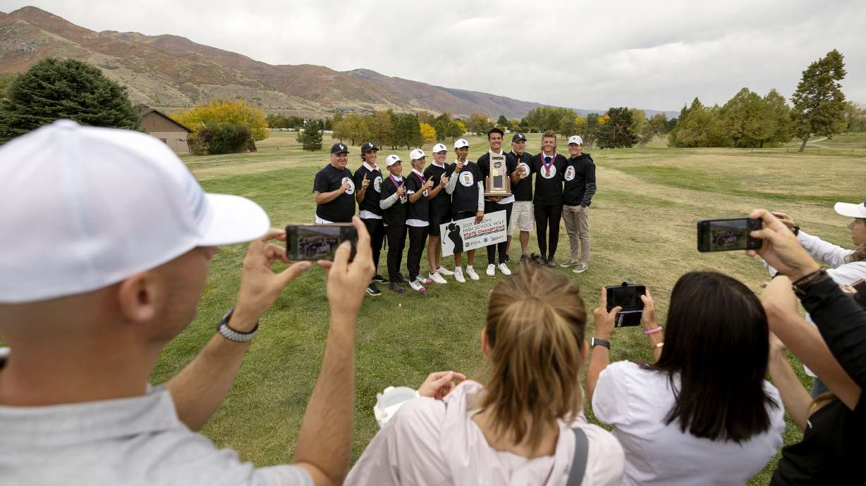 Lone Peak players and coaches pose for photos after winning the 6A boys state tournament at Davis Park Golf Course in Kaysville on Tuesday, Oct. 5, 2021.