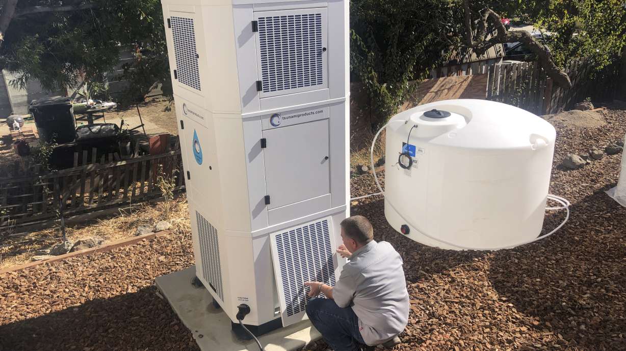 Ted Bowman, design engineer with Tsunami Products, installs a unit in homeowner Don Johnson's backyard in Benicia, Calif., Sept. 28. The recent invention can make water out of the air.