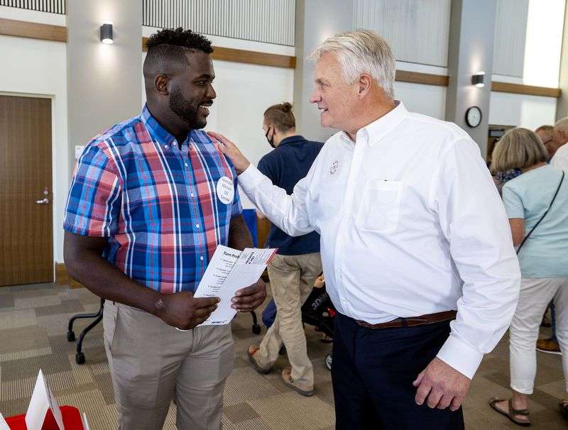 Nick Mitchell, a U.S. Senate candidate, left, talks
with Cottonwood Heights City Council candidate David Rawlings, at a
meet-the-candidates meeting in Cottonwood Heights on Tuesday, Sept.
14.