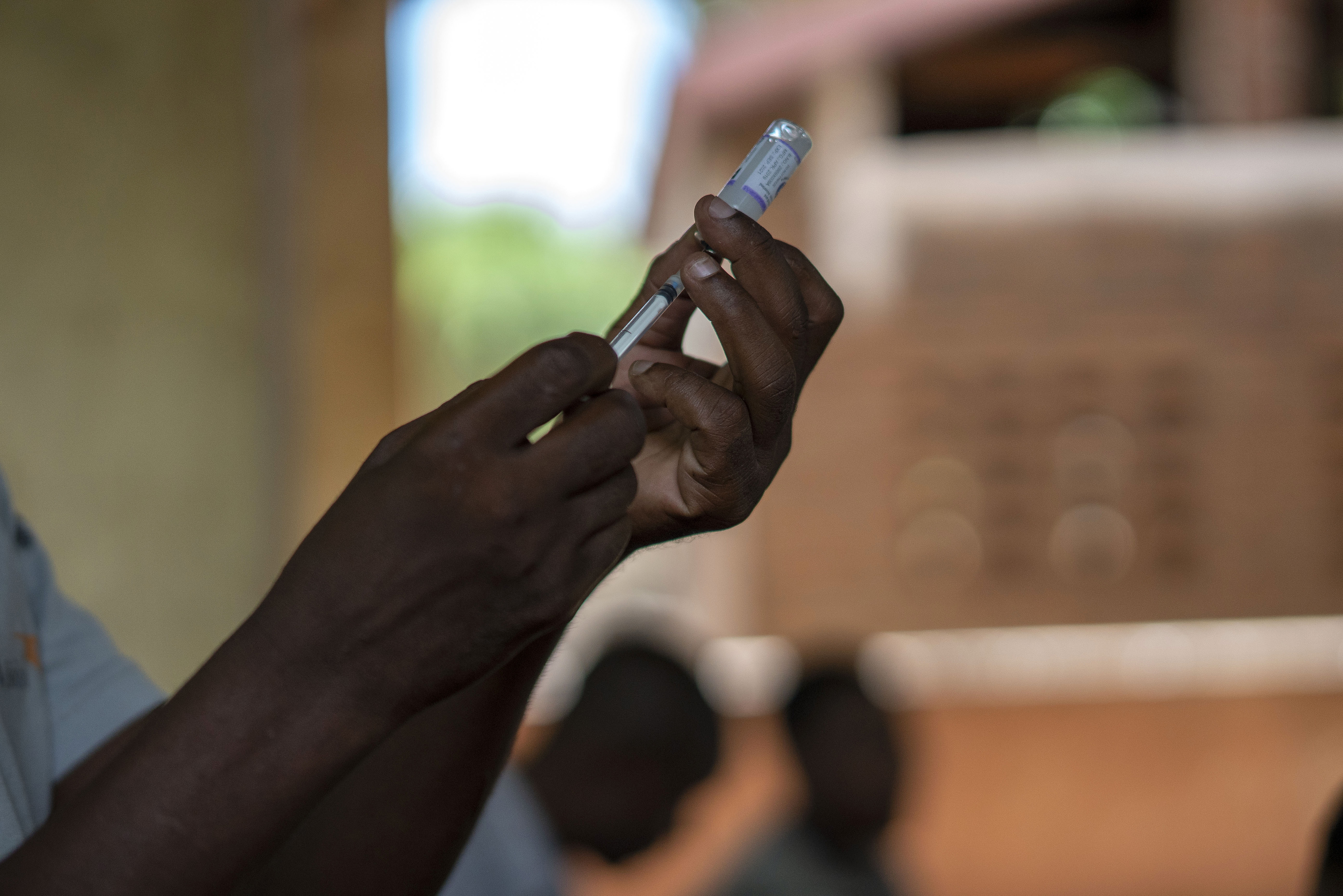 Health officials prepare to give a vaccine to residents of the Malawi village of Tomali, where young children become test subjects for the world's first vaccine against malaria, on Dec. 11, 2019. The World Health Organization recommended that the world’s first malaria vaccine be given to children across Africa, in a move officials hope will spur the stalled progress against efforts to curb the spread of the parasitic disease.