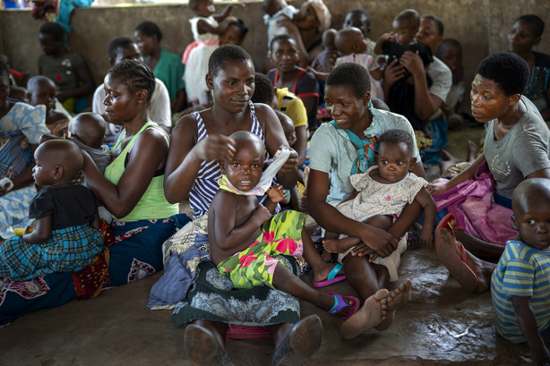 Residents of the Malawi village of Tomali wait to have their young children become test subjects for the world's first vaccine against malaria in a pilot program on Dec. 11, 2019. The world’s first malaria vaccine should be given to children across Africa, the World Health Organization recommended Wednesday, a move that officials hope will spur stalled efforts to curb the spread of the parasitic disease.