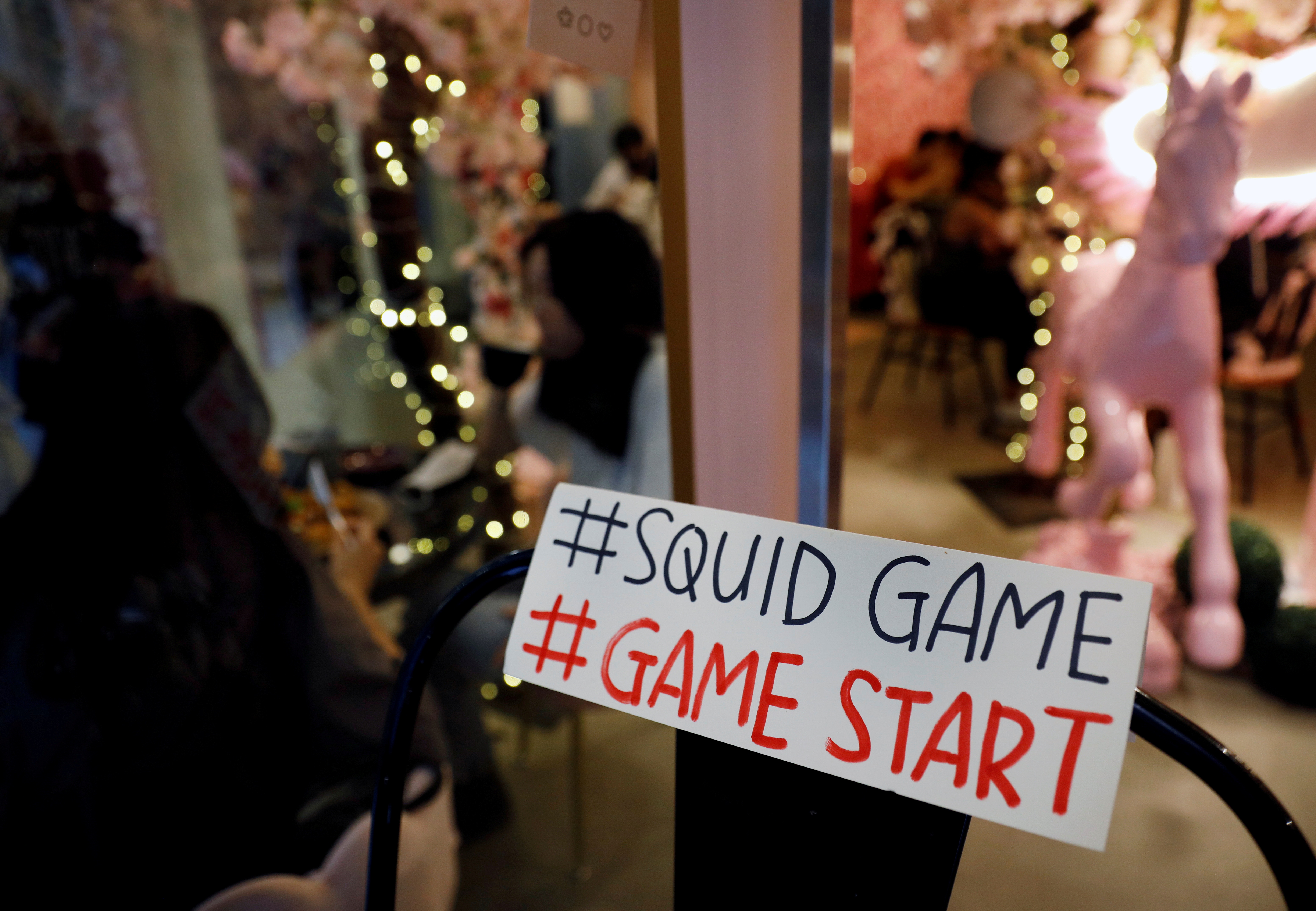 A sign referring to the "honeycomb challenge" featured in Netflix's new hit series "Squid Game" is seen at Brown Butter Cafe in Singapore Oct. 1. Relief is coming for a woman who was deluged with thousands of prank calls and text messages after her phone number was featured in the Netflix show. 