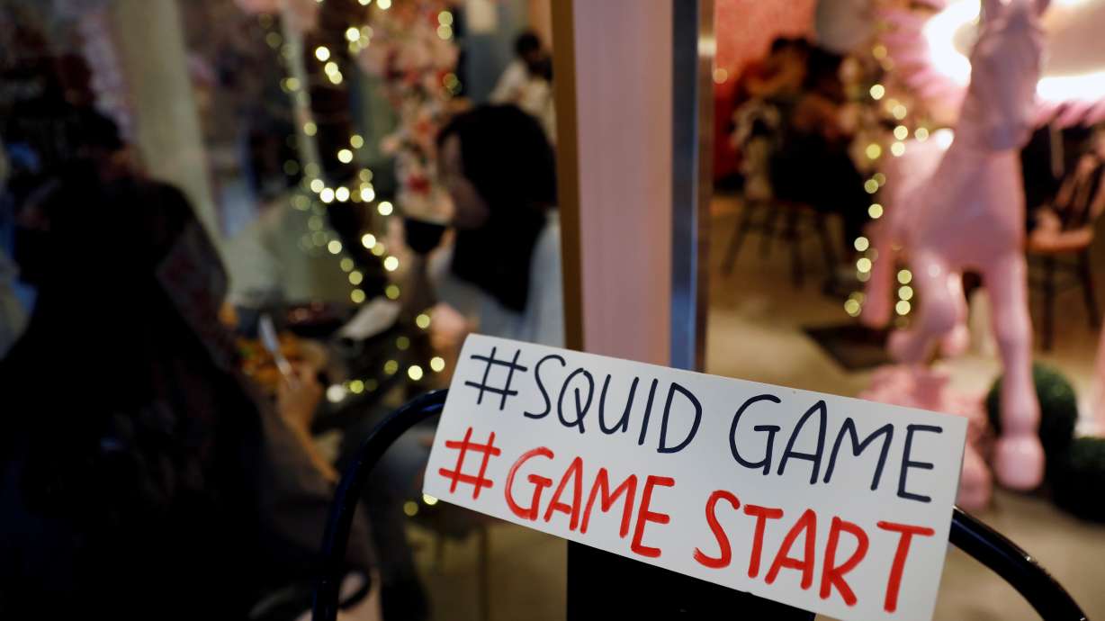 A sign referring to the "honeycomb challenge" featured in Netflix's new hit series "Squid Game" is seen at Brown Butter Cafe in Singapore Oct. 1. Relief is coming for a woman who was deluged with thousands of prank calls and text messages after her phone number was featured in the Netflix show.