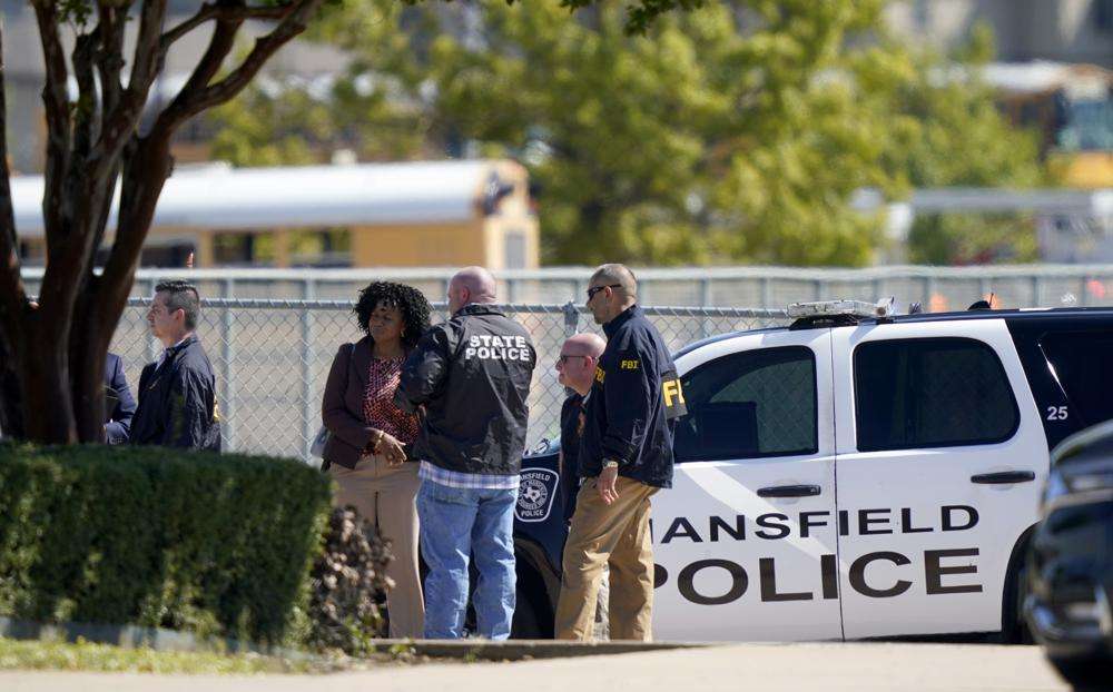 Law enforcement officers from different agencies gather in the parking lot of Timberview High School after a shooting inside the school located in south Arlington, Texas, Wednesday.