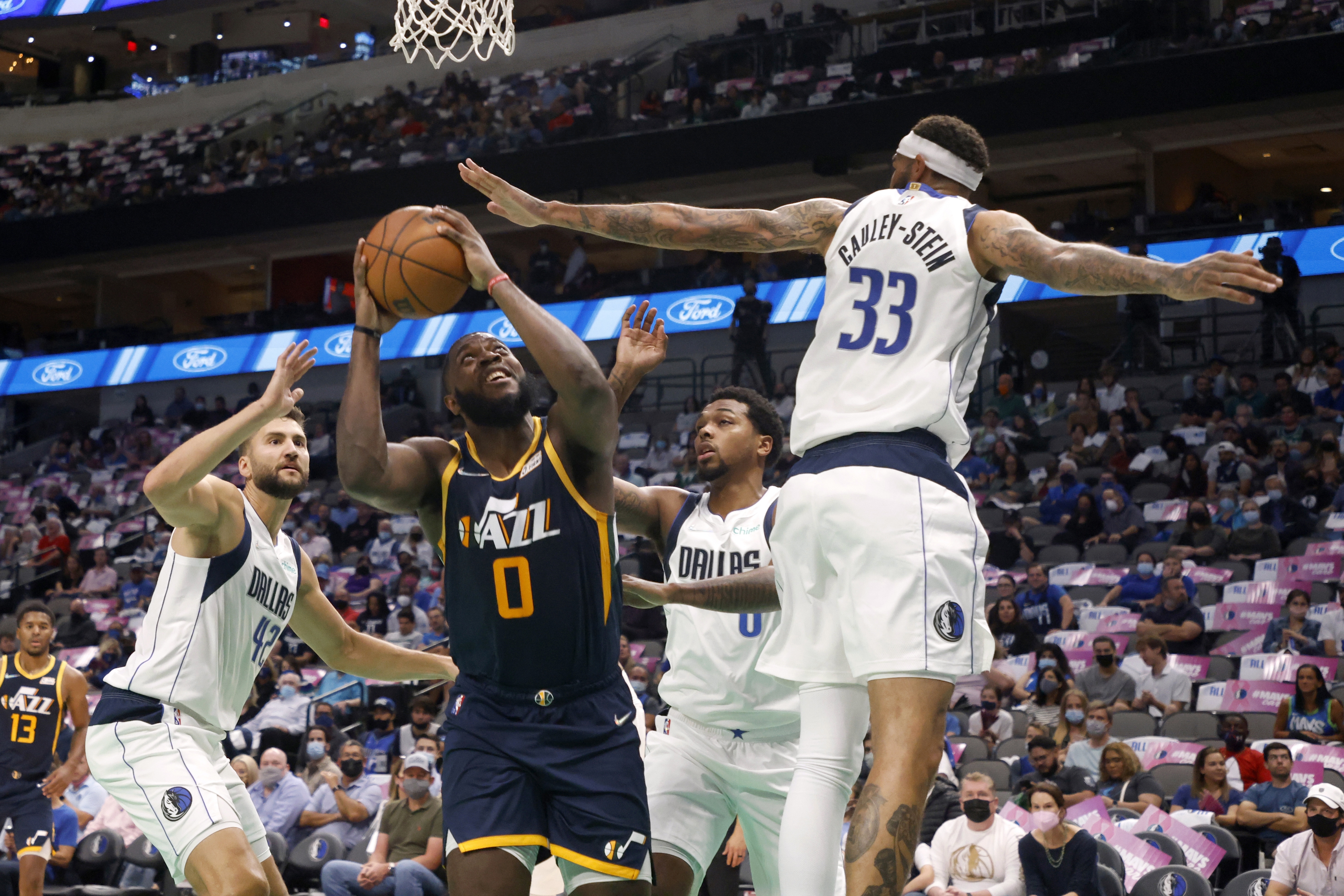 Dallas Mavericks' Maxi Kleber (42), Sterling Brown (0) and Willie Cauley-Stein (33) defend as Utah Jazz forward Eric Paschall (0) looks for a shot during the first half of a preseason NBA basketball game in Dallas, Wednesday, Oct. 6, 2021.