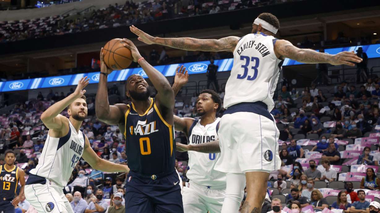 Dallas Mavericks' Maxi Kleber (42), Sterling Brown (0) and Willie Cauley-Stein (33) defend as Utah Jazz forward Eric Paschall (0) looks for a shot during the first half of a preseason NBA basketball game in Dallas, Wednesday, Oct. 6, 2021.