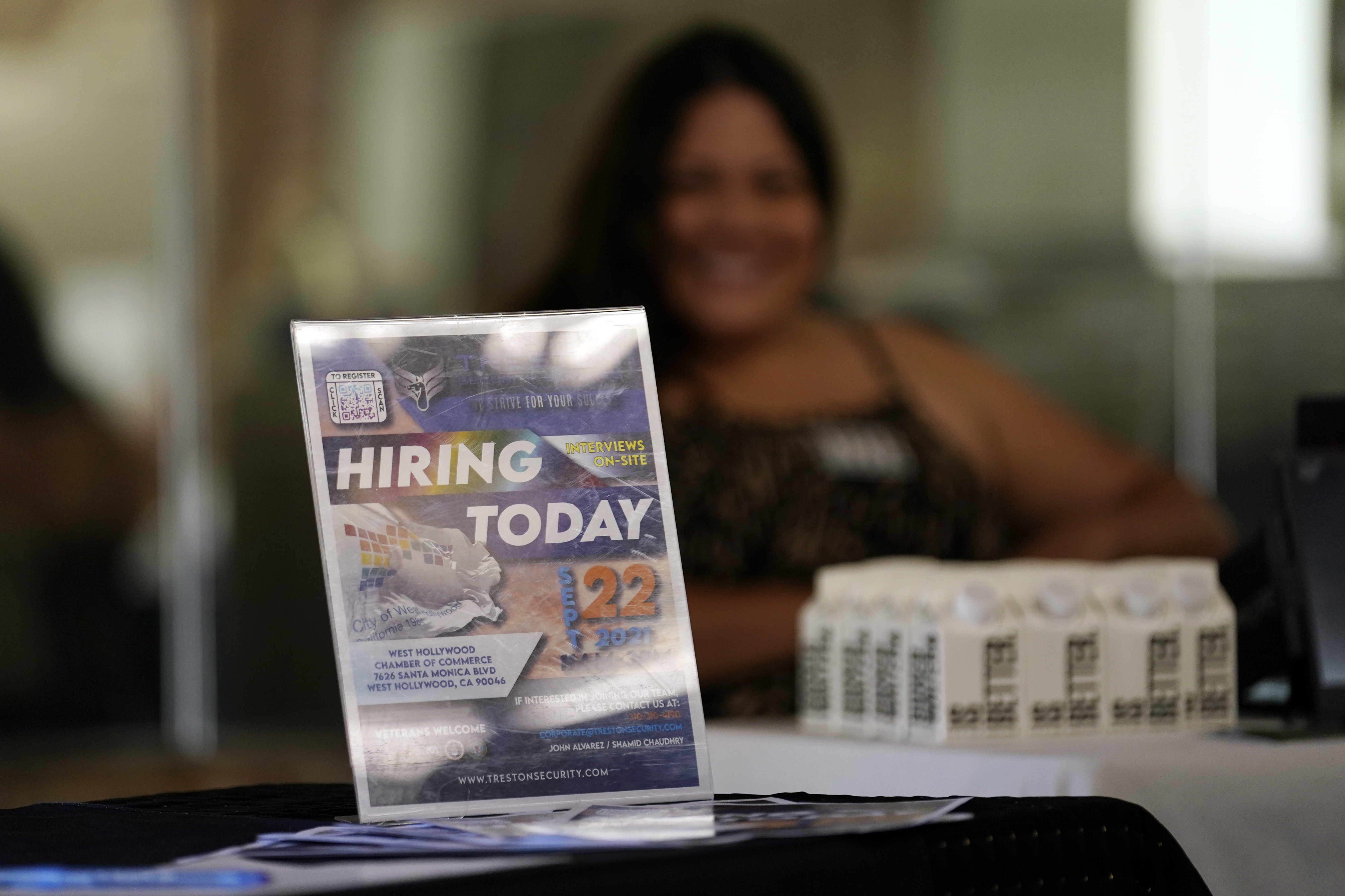 A hiring sign is seen during a job fair Sept. 22, in Los Angeles. The number of Americans applying for unemployment benefits fell last week.