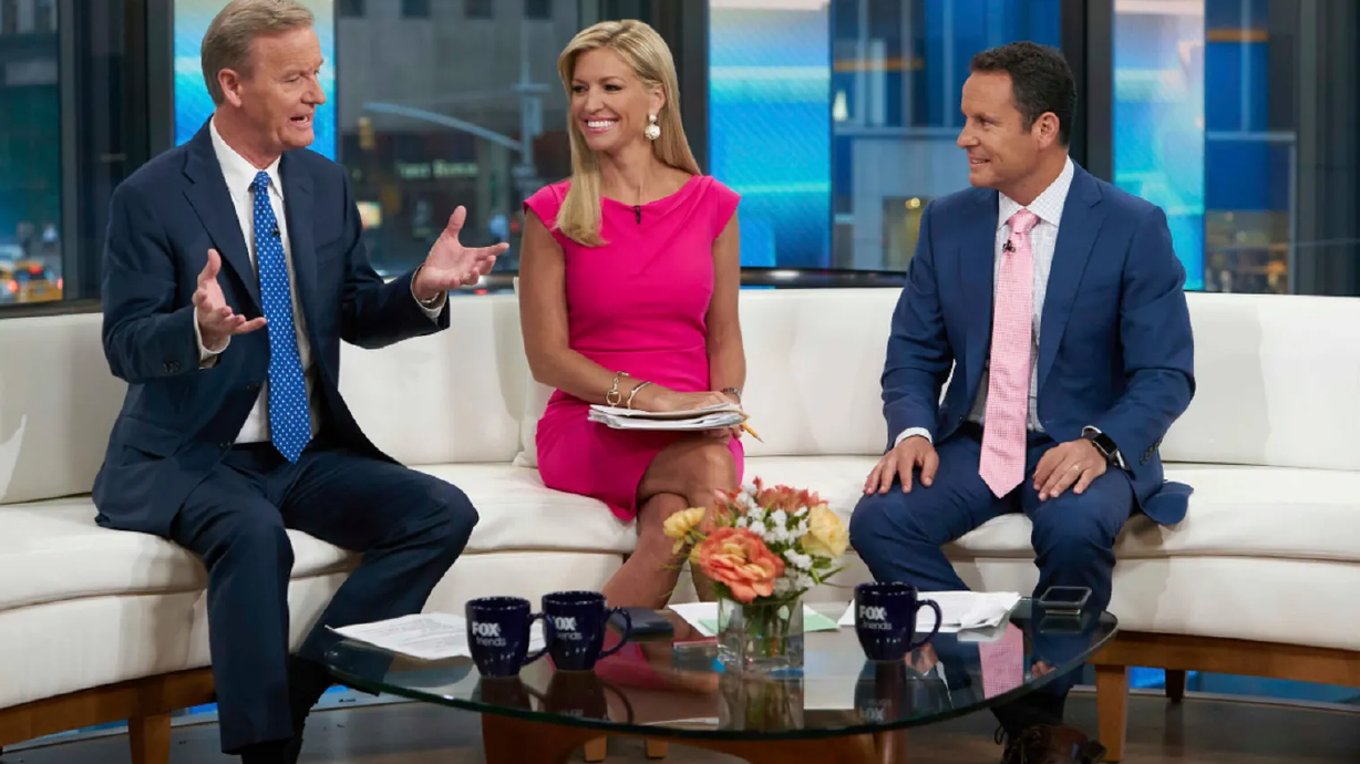 Steve Doocy, left, co-host of “Fox & Friends,” is pictured on the Fox News Channel in 2021. Doocy is among several Fox News personalities who have been with the network since it first signed on at 6 a.m. on Oct. 7, 1996.