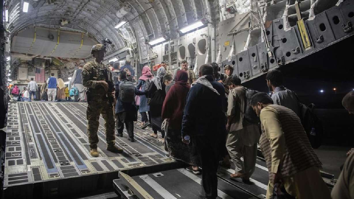 Afghan passengers board a U.S. Air Force C-17 Globemaster III during the Afghanistan evacuation at Hamid Karzai International Airport in Kabul, Afghanistan Aug. 22. An Afghan man who worked for the U.S. government in Afghanistan says the Biden administration has ignored his pleas for help to evacuate his two young sons from Afghanistan after their mother died of a heart attack while being threatened by the Taliban.
