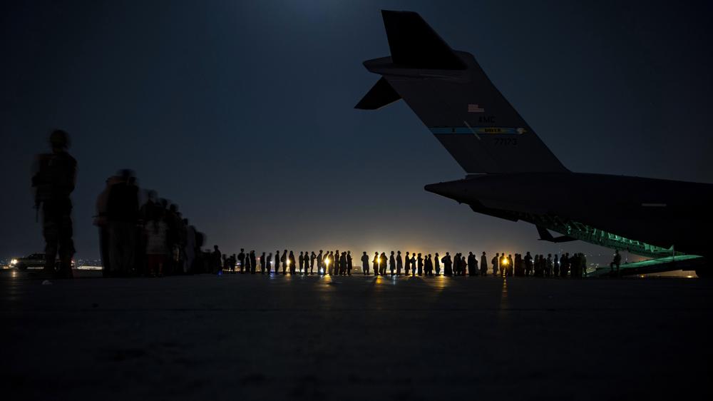 U.S. Air Force aircrew, prepare to load qualified evacuees aboard a U.S. Air Force C-17 Globemaster III aircraft in support of the Afghanistan evacuation at Hamid Karzai International Airport, Kabul, Afghanistan, Aug. 22. An Afghan man who worked for the U.S. government in Afghanistan says the Biden administration has ignored his pleas for help to evacuate his two young sons from Afghanistan after their mother died of a heart attack while being threatened by the Taliban.