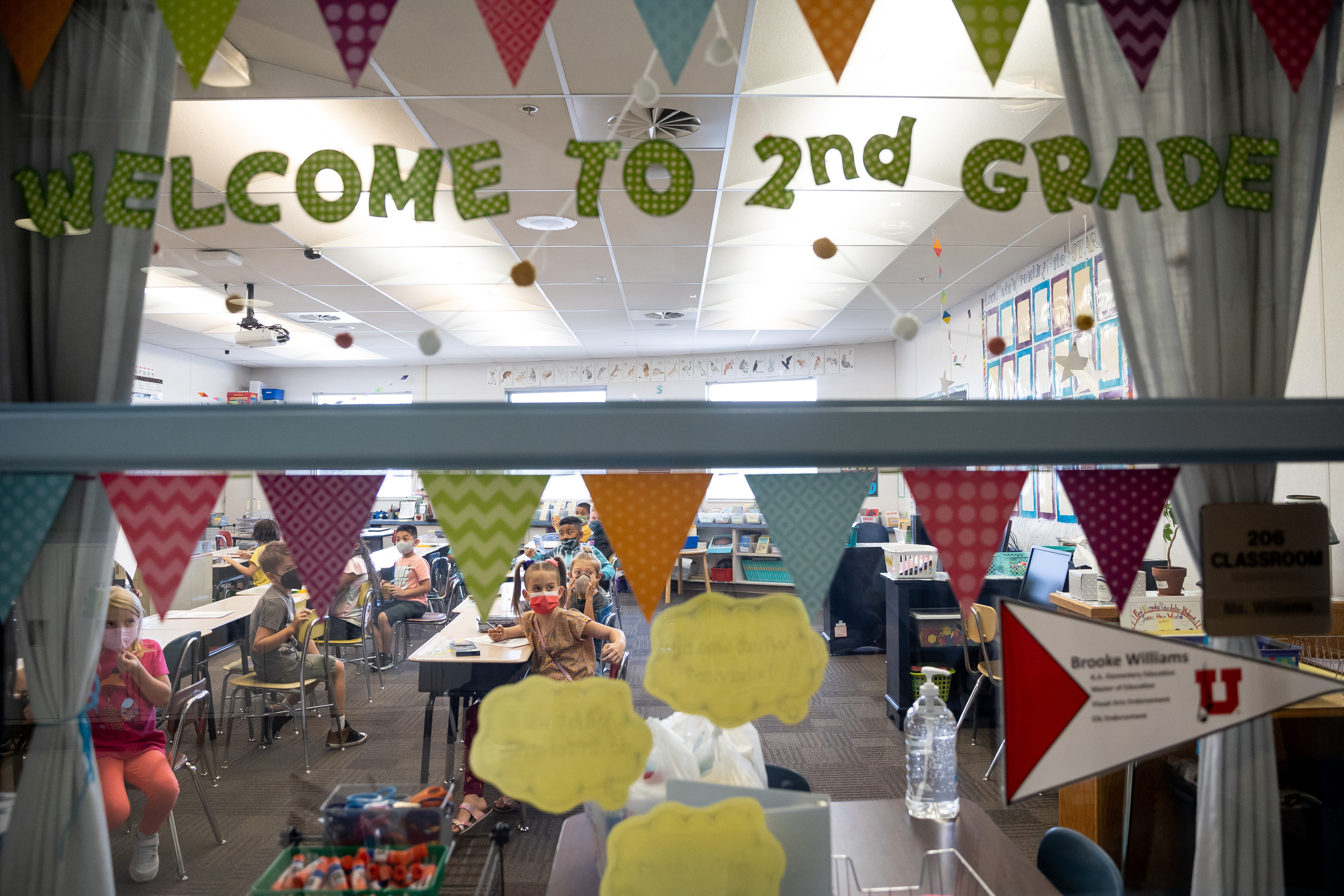 Second grade students are pictured through the window of their classroom at Nibley Park School in Salt Lake City on Aug. 24, 2021.