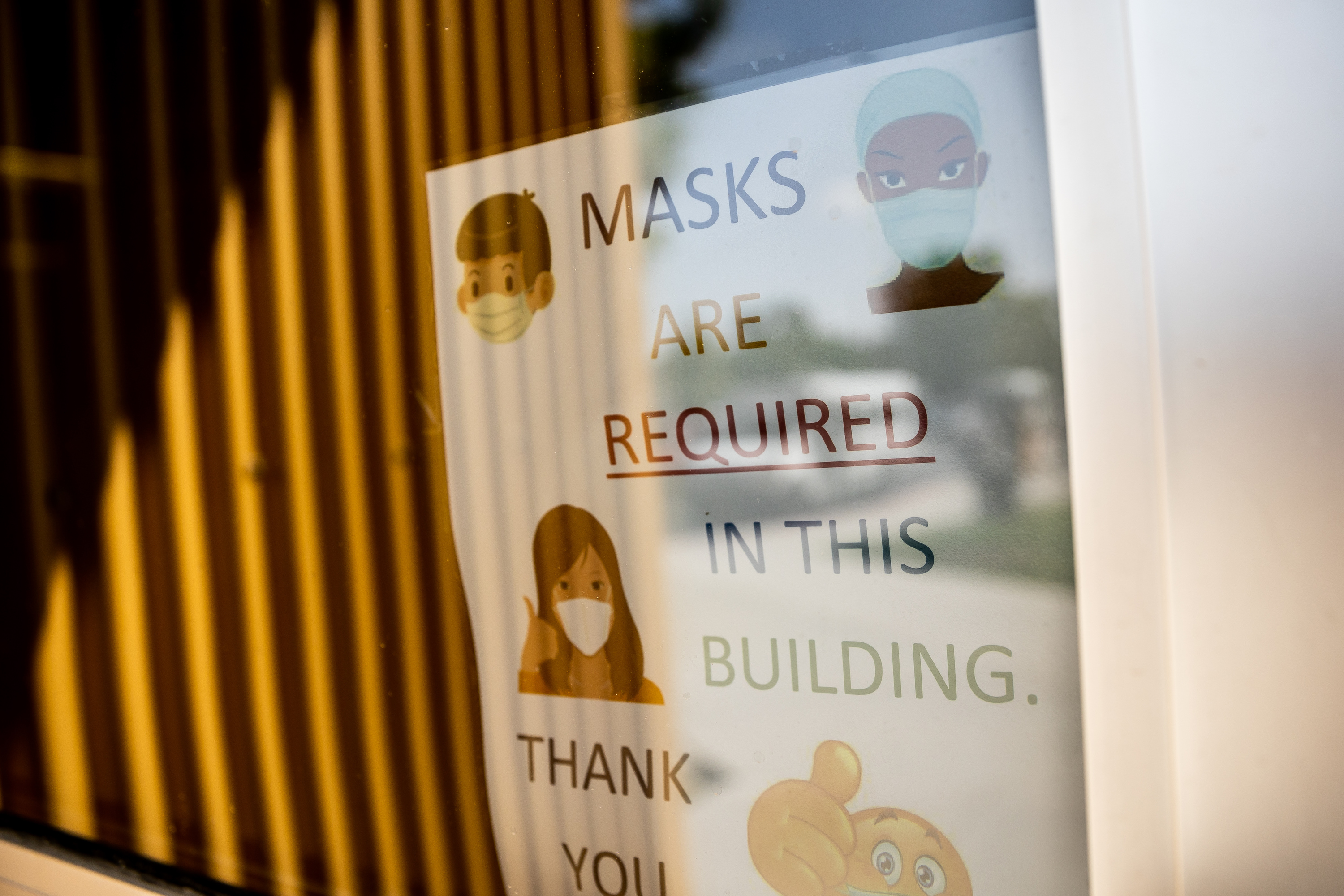 Signage indicates that masks are required inside Nibley Park School in Salt Lake City on Tuesday, Aug. 24, 2021.