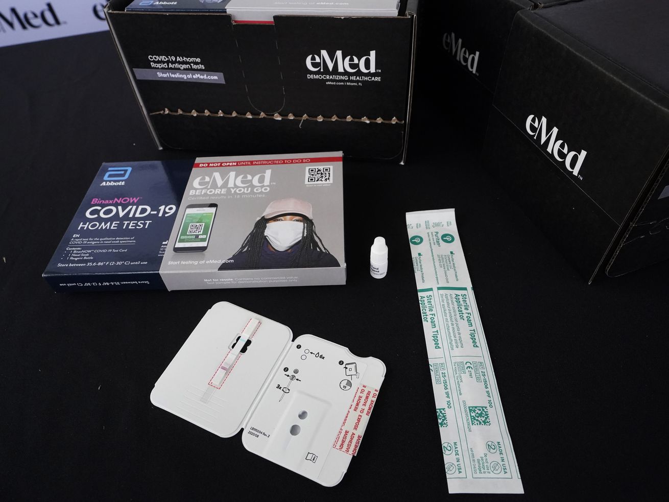 The contents of a COVID-19 home rapid testing kit is
shown during a news conference on May 20, at the
Frederick Douglass Elementary School in the Overtown neighborhood
of Miami.