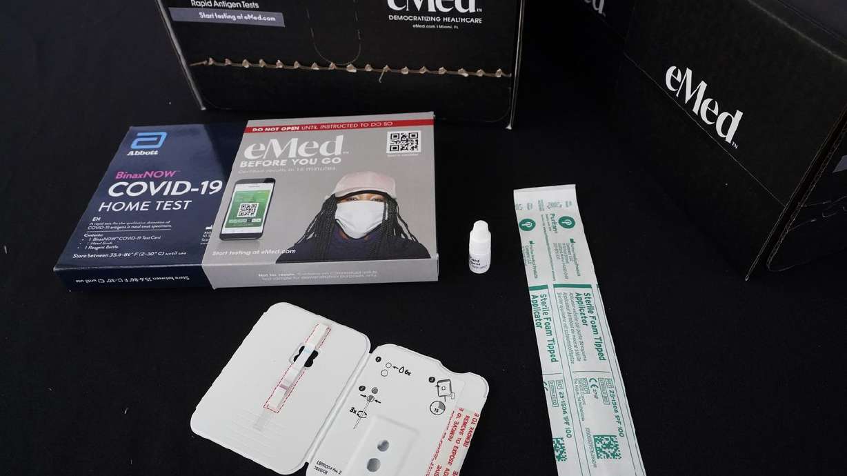 The contents of a COVID-19 home rapid testing kit is
shown during a news conference on May 20, at the
Frederick Douglass Elementary School in the Overtown neighborhood
of Miami.