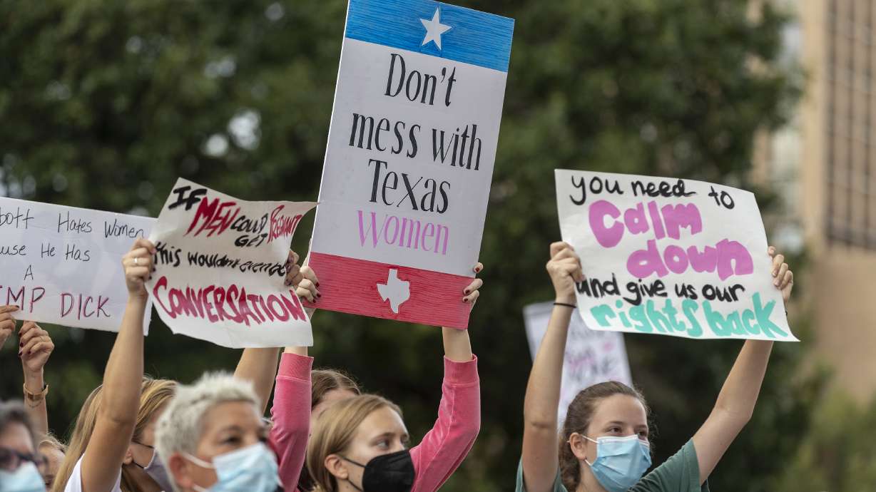 People attend the Women's March ATX rally, at the Texas State Capitol in Austin, Texas, on Oct. 2. A federal judge has ordered Texas to suspend a new law that has banned most abortions in the state since September. The order Wednesday by U.S. District Judge Robert Pitman freezes for now the strict abortion law known as Senate Bill 8.