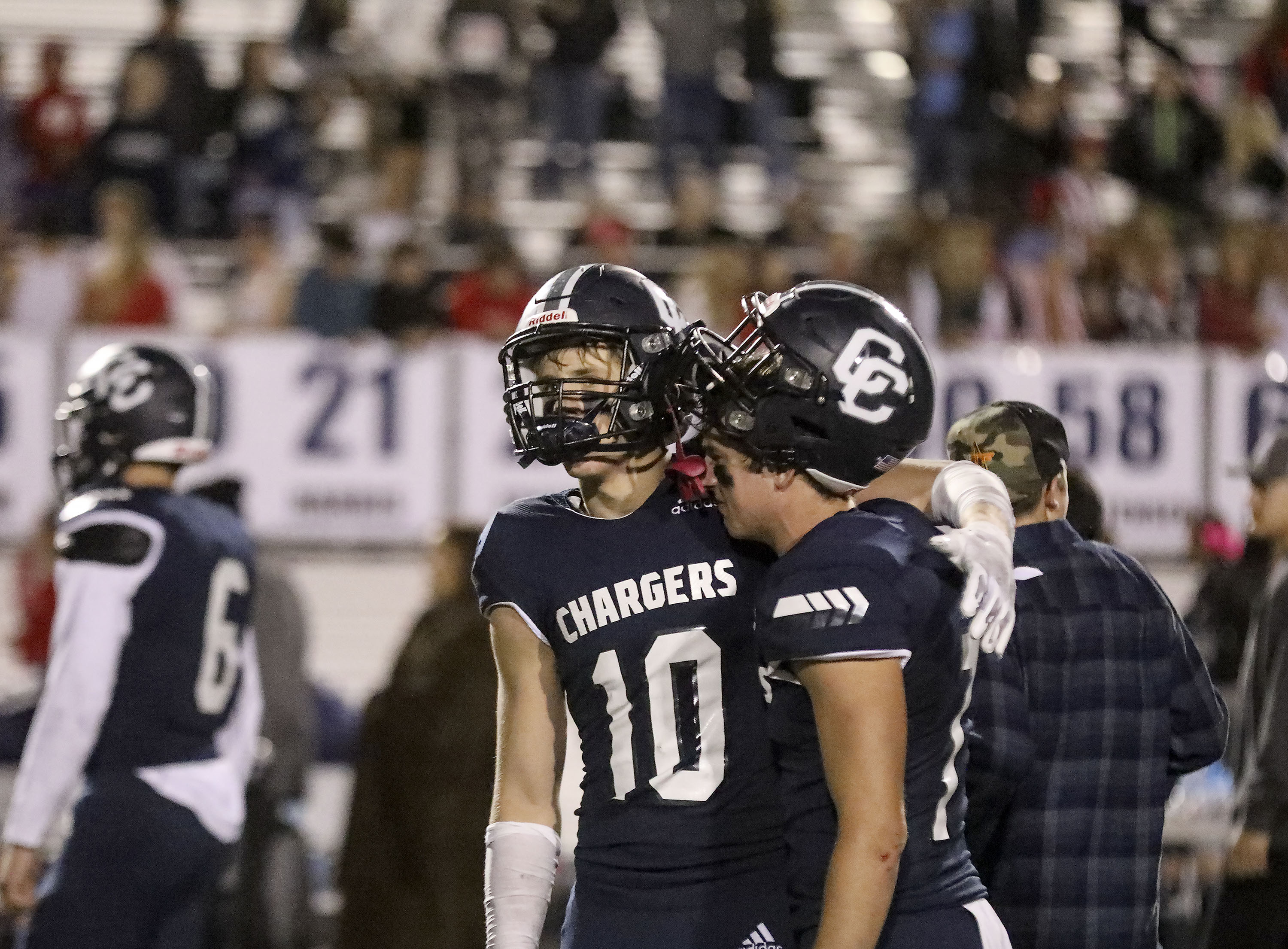 Corner Canyon players console each other after a loss to Lone Peak that ended their 48-game winning streak at Corner Canyon High School in Draper on Thursday, Oct. 7, 2021.