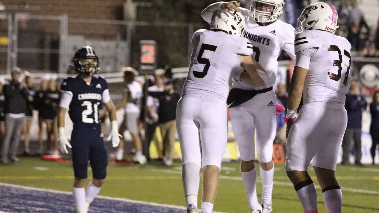 Lone Peak’s Luke Durfey, Easton Comer and Savea Fitisemanu celebrate a touchdown against Corner Canyon at Corner Canyon High School in Draper on Thursday, Oct. 7, 2021.