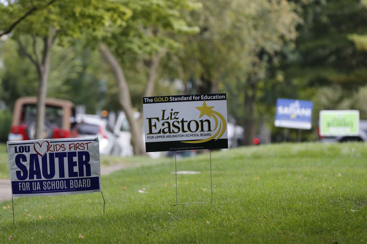 Campaign yard signs line a street Thursday, in Upper Arlington, Ohio.
