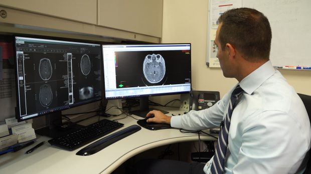 Dr. Jaden Evans, a radiation oncologist at McKay-Dee Hospital in Ogden, uses stereotactic radiosurgery to pinpoint cancerous tumors in Erika Merrill’s brain without damaging the healthy tissue in her brain. He plans the treatment out through programming on his computer before she receives it in person.