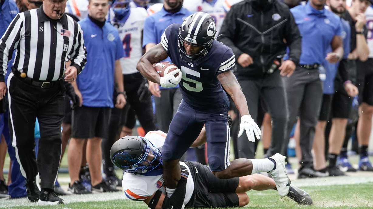Brigham Young wide receiver Chris Jackson (5) gets tackled by Boise State cornerback Kaonohi Kaniho during an NCAA college football game at LaVell Edwards Stadium in Provo on Saturday, Oct. 9, 2021.