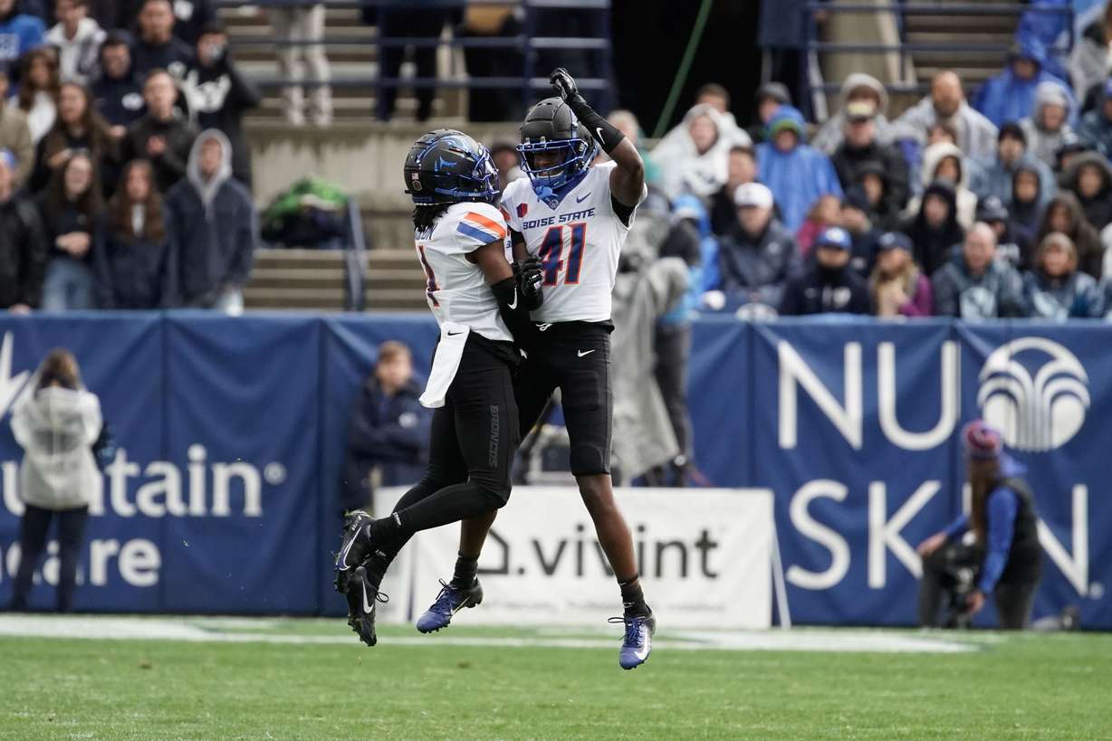 Boise State players celebrate after an intercept against BYU during an NCAA college football game at LaVell Edwards Stadium in Provo on Saturday, Oct. 9, 2021.