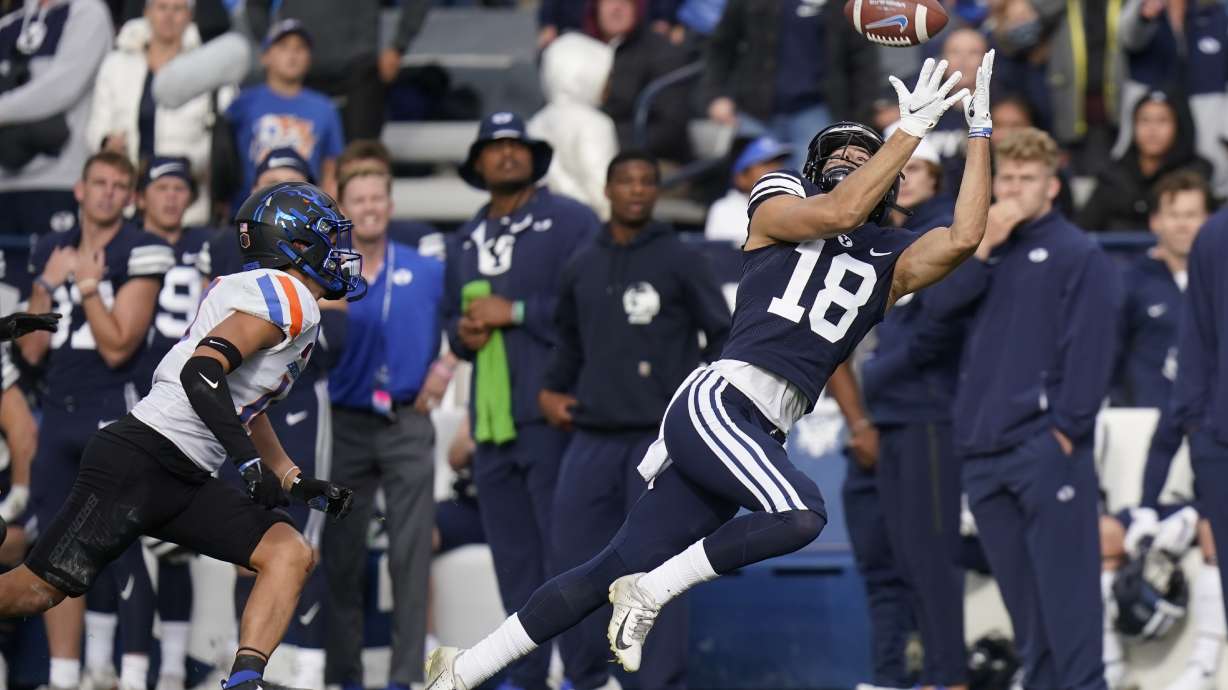 BYU wide receiver Gunner Romney (18) catches a pass as Boise State cornerback Kaonohi Kaniho, left, defends in the second half during an NCAA college football game Saturday, Oct. 9, 2021, in Provo, Utah.