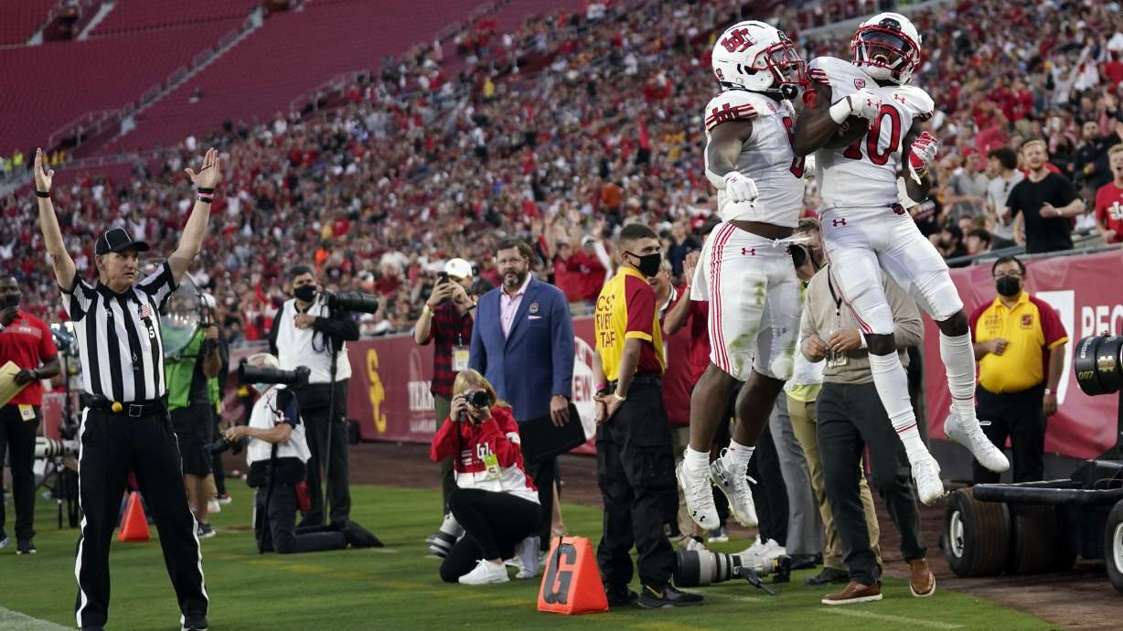Utah wide receiver Money Parks (10) celebrates his touchdown reception with running back TJ Pledger during the first half of the team's NCAA college football game against Southern California on Saturday, Oct. 9, 2021, in Los Angeles.