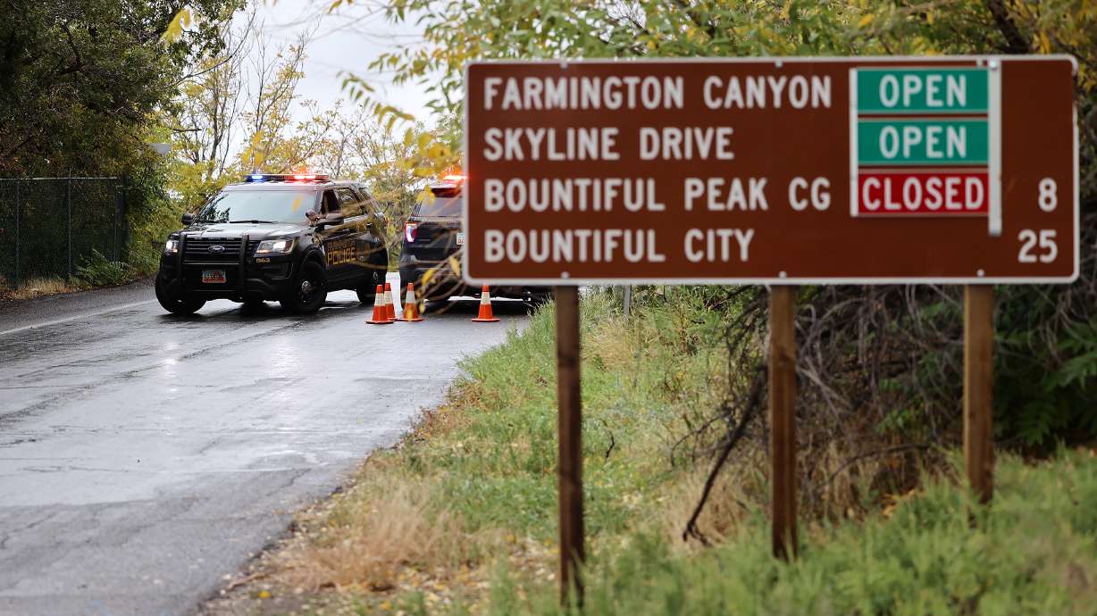 Farmington police officers block the road up Farmington Canyon on Saturday. Approximately 87 individuals participating in an ultra-marathon in the mountains above Davis County were caught in about 12-18 inches of snow and near whiteout conditions.