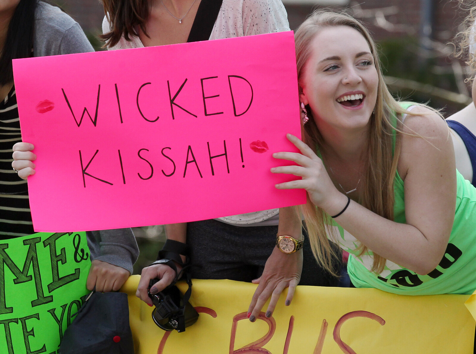 The Boston Marathon is set to go on Monday, for the first time since April 2019 and race organizers are asking spectators to refrain from kissing the runners, and pictured, a Wellesley College student holds a sign for Boston Marathon runners in April 2016.