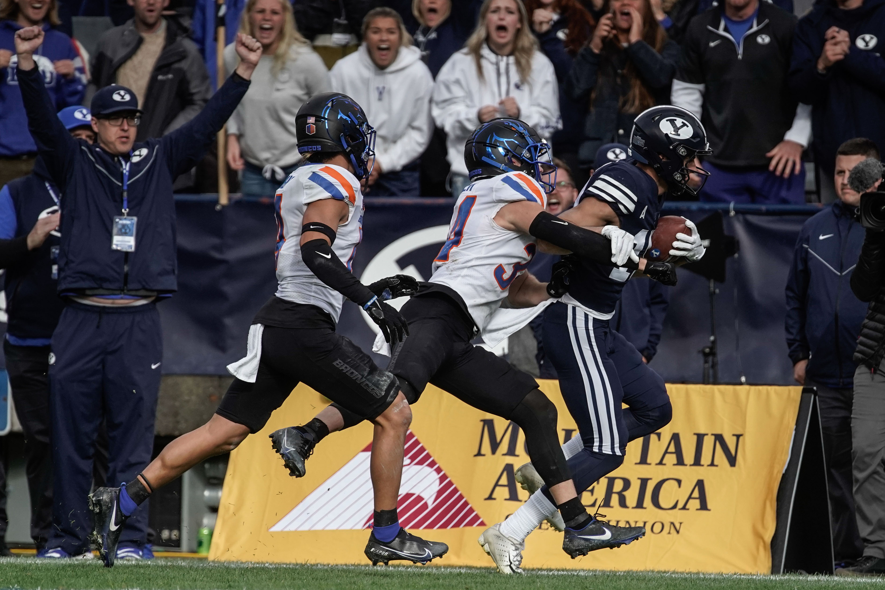BYU wide receiver Gunner Romney runs past Boise State 's Alexander Teubner, front, and Kaonohi Kaniho after a long reception during an NCAA college football game at LaVell Edwards Stadium in Provo on Saturday, Oct. 9, 2021.
