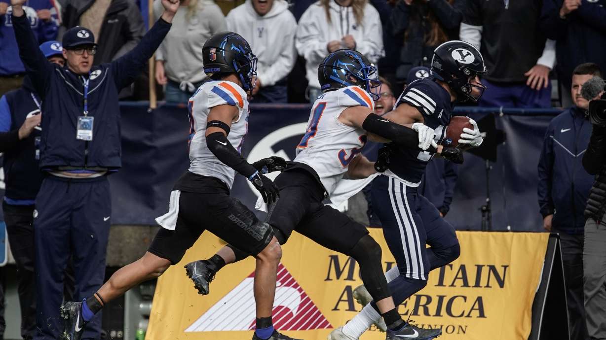 BYU wide receiver Gunner Romney runs past Boise State 's Alexander Teubner, front, and Kaonohi Kaniho after a long reception during an NCAA college football game at LaVell Edwards Stadium in Provo on Saturday, Oct. 9, 2021.