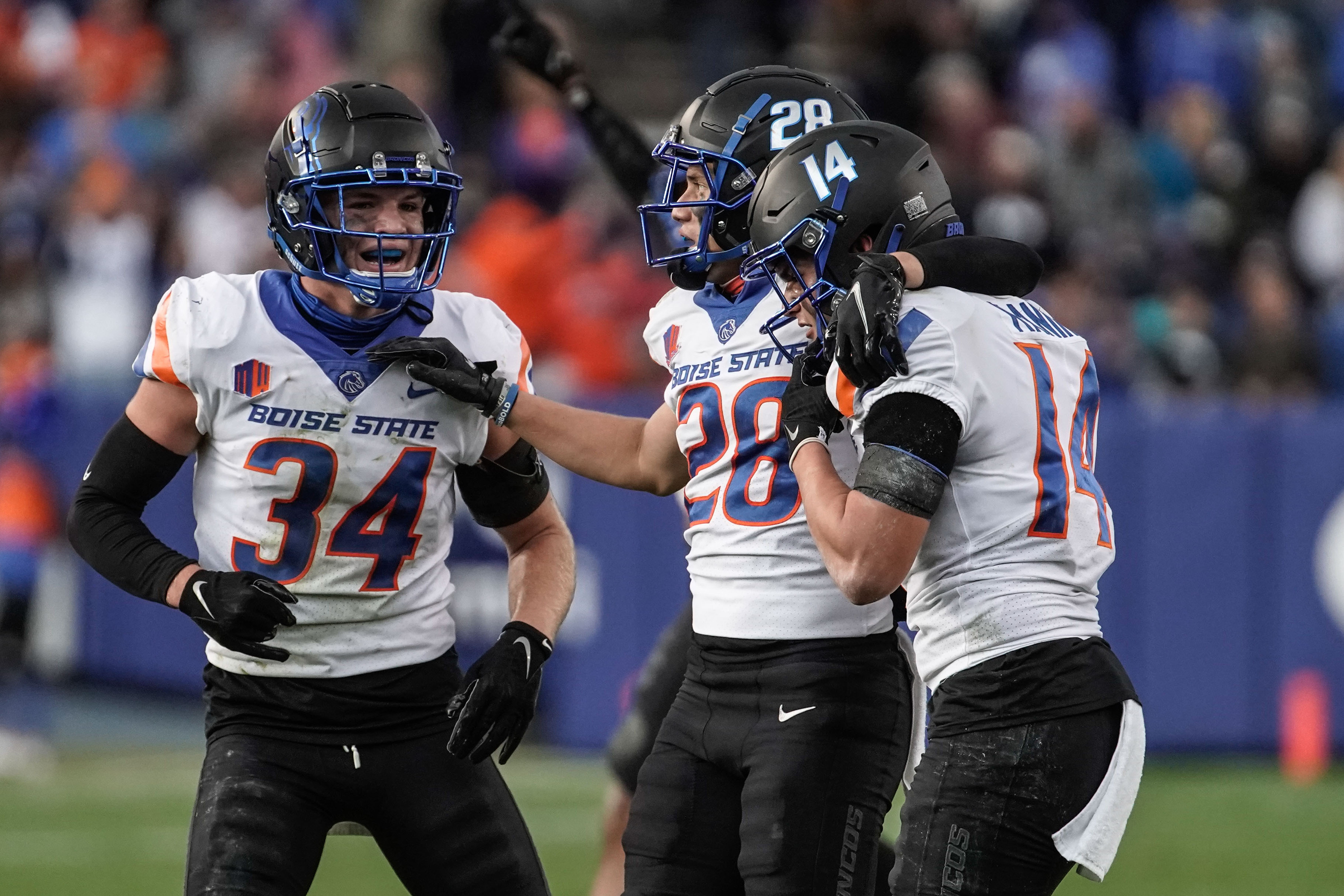 Boise State players celebrate a turnover as they compete against BYU during an NCAA college football game at LaVell Edwards Stadium in Provo on Saturday, Oct. 9, 2021.