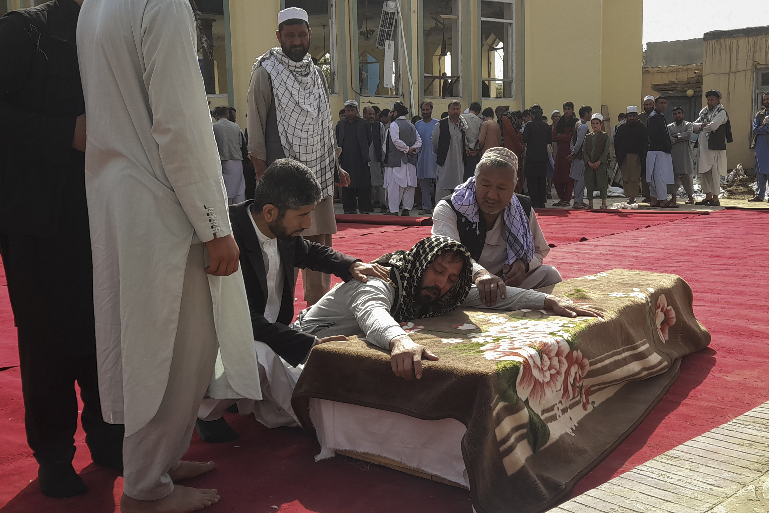 Relatives and residents attend a funeral ceremony for victims of a suicide attack at the Gozar-e-Sayed Abad Mosque in Kunduz, northern Afghanistan, Saturday. The mosque was packed with Shiite Muslim worshippers when an Islamic State suicide bomber attacked during Friday prayers, killing dozens in the latest security challenge to the Taliban as they transition from insurgency to governance. 