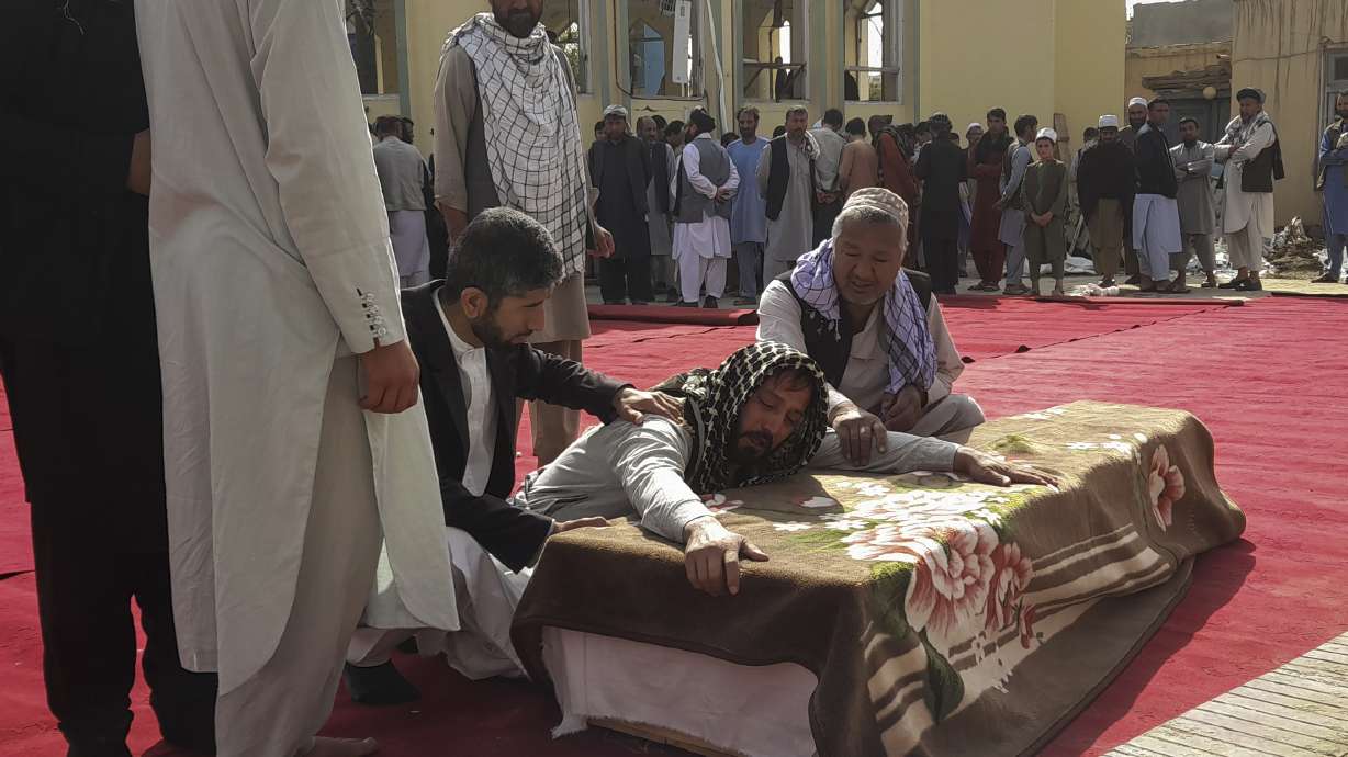Relatives and residents attend a funeral ceremony for victims of a suicide attack at the Gozar-e-Sayed Abad Mosque in Kunduz, northern Afghanistan, Saturday. The mosque was packed with Shiite Muslim worshippers when an Islamic State suicide bomber attacked during Friday prayers, killing dozens in the latest security challenge to the Taliban as they transition from insurgency to governance.