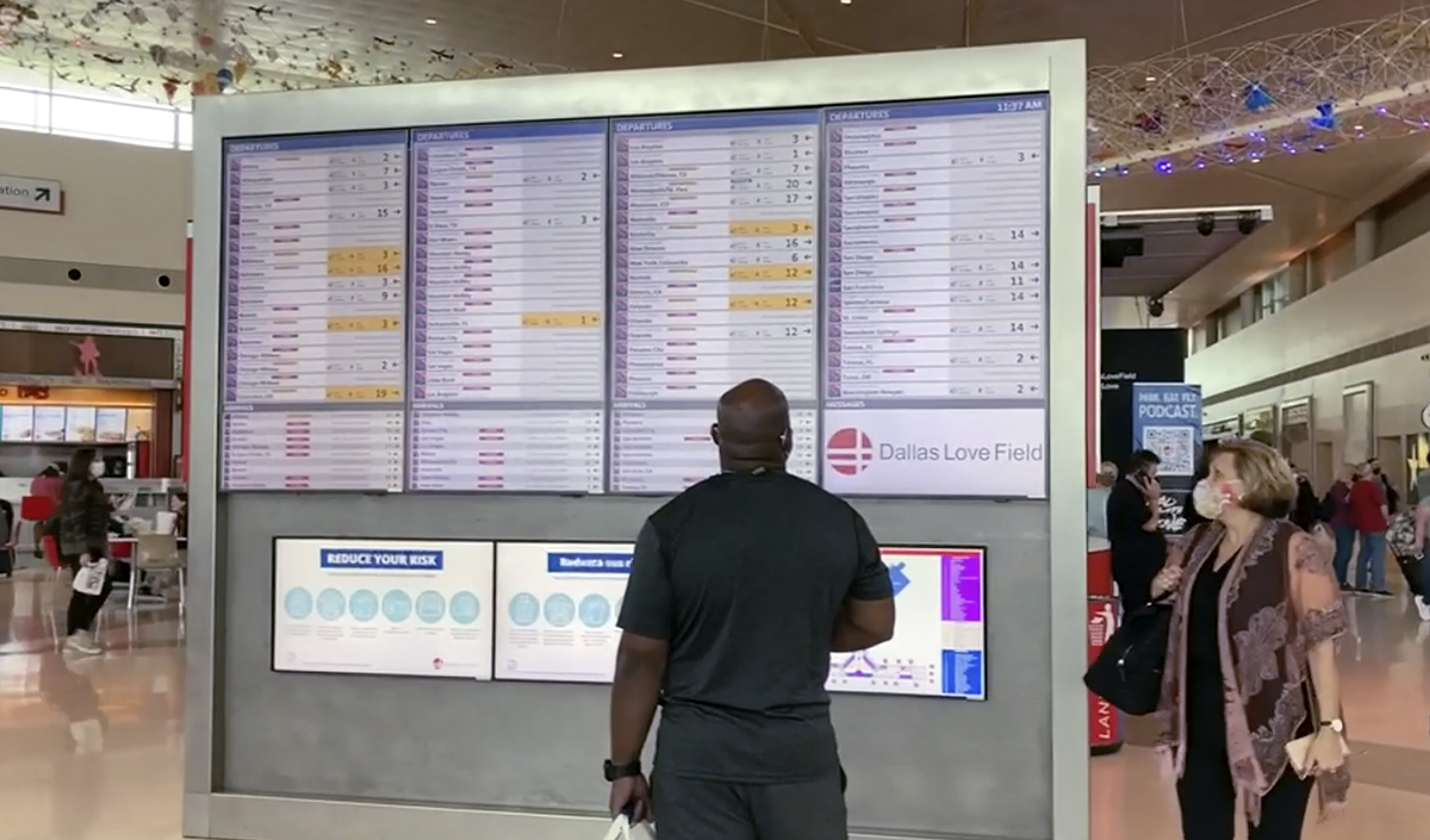 In this frame grab from cellphone video, passengers look for information on their flights, Sunday, at Dallas Love Field. Southwest Airlines canceled hundreds of flights over the weekend, blaming the woes on air traffic control issues and weather.