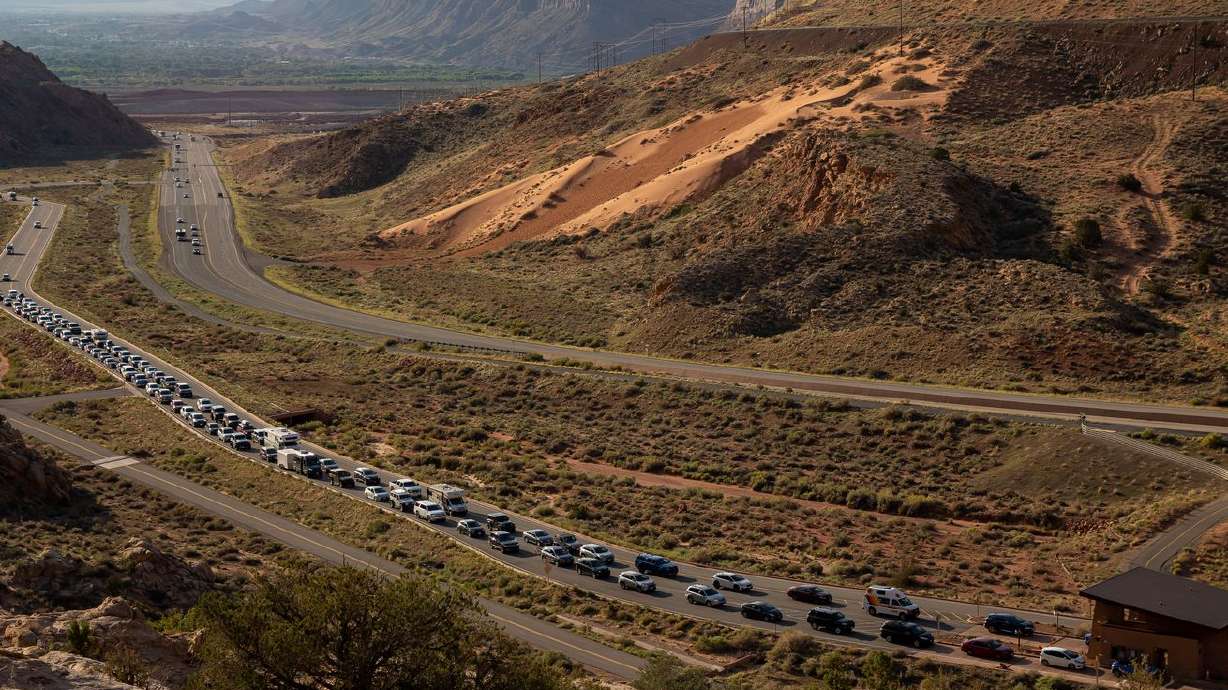 The entrance road to Arches National Park outside Moab
begins to back up with visitors on Sunday, Sept. 19.