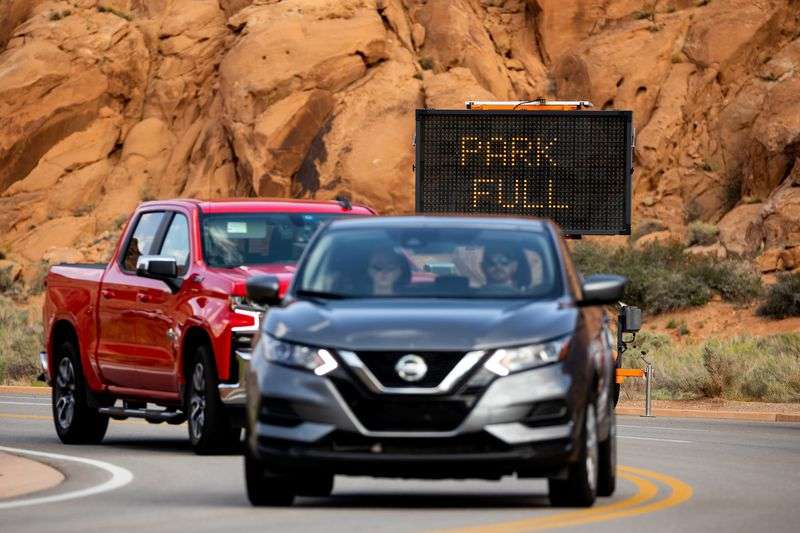 Signage warns approaching cars that Arches National Park is restricting additional entries due to crowding on Sunday, Sept. 19.