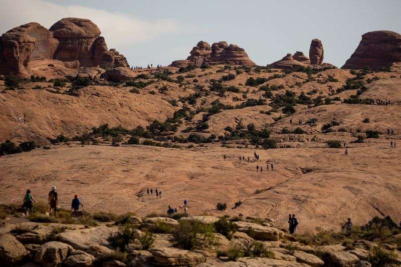 Visitors to Arches National Park make the hike to and from Delicate Arch, one of the park’s most popular attractions, on
Sunday, Sept. 19.