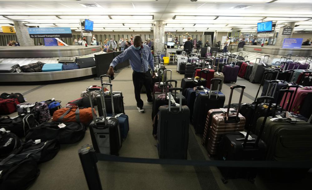 Unclaimed baggages wells up between carousels for passengers arriving on Southwest Airlines flights at Denver International Airport late Sunday in Denver. Southwest Airlines canceled hundreds of flights over the weekend, blaming the woes on air traffic control issues and weather.
