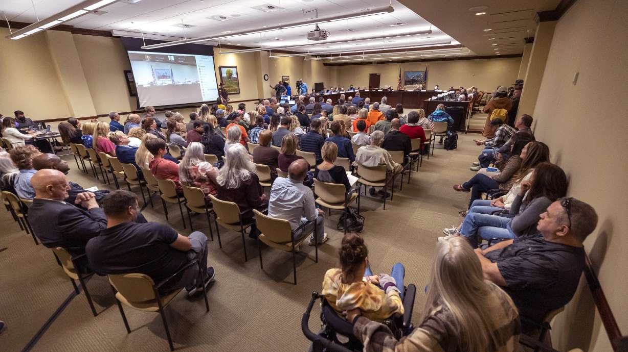 People listen as others express their opinions about the Biden administration’s COVID-19 vaccine mandate during a meeting of the Utah Legislature's Business and Labor Interim Committee at the Capitol in Salt Lake City on Oct. 4.