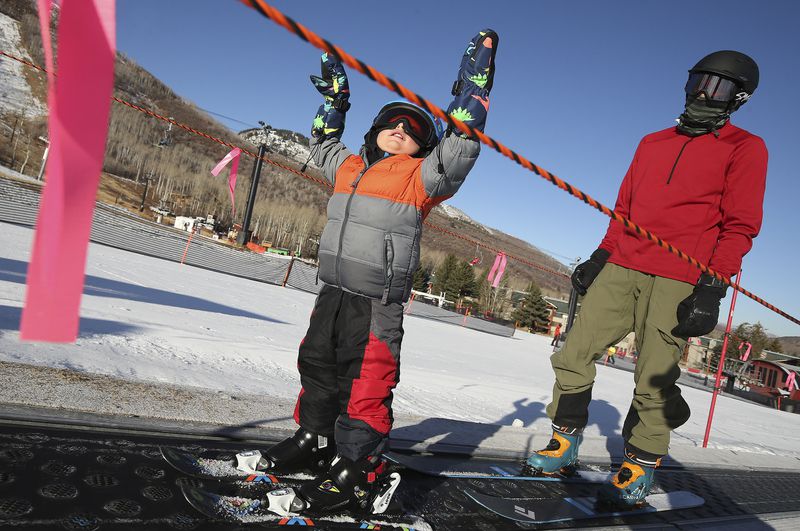 Blaine Gilmore, 2, enjoys Mine Cart lift with his
father, Roland Gilmore, as Park City Mountain Resort in Park City
opens for the 2020-21 ski season on Nov. 20, 2020.