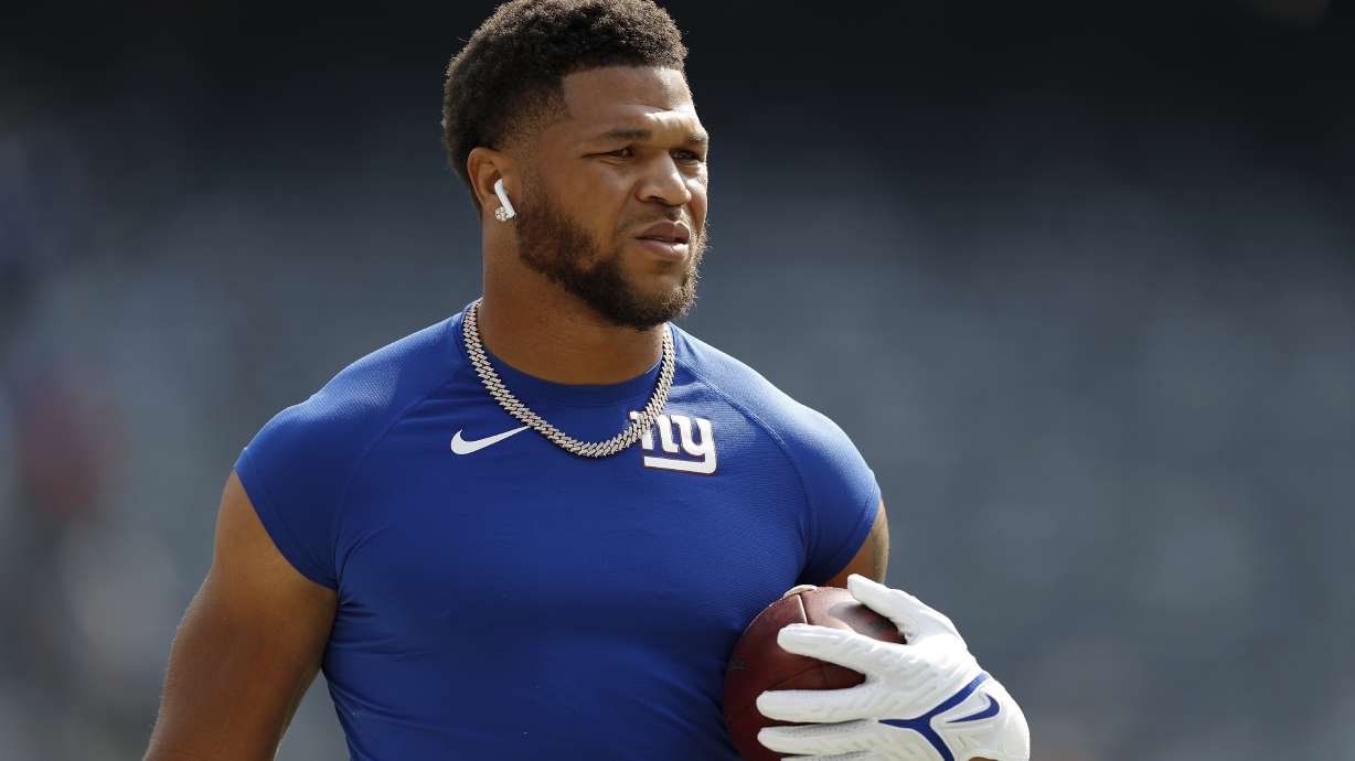 New York Giants running back Devontae Booker (28) warms up before an NFL football game against the Denver Broncos, Sunday, Sept. 12, 2021, in East Rutherford, N.J.