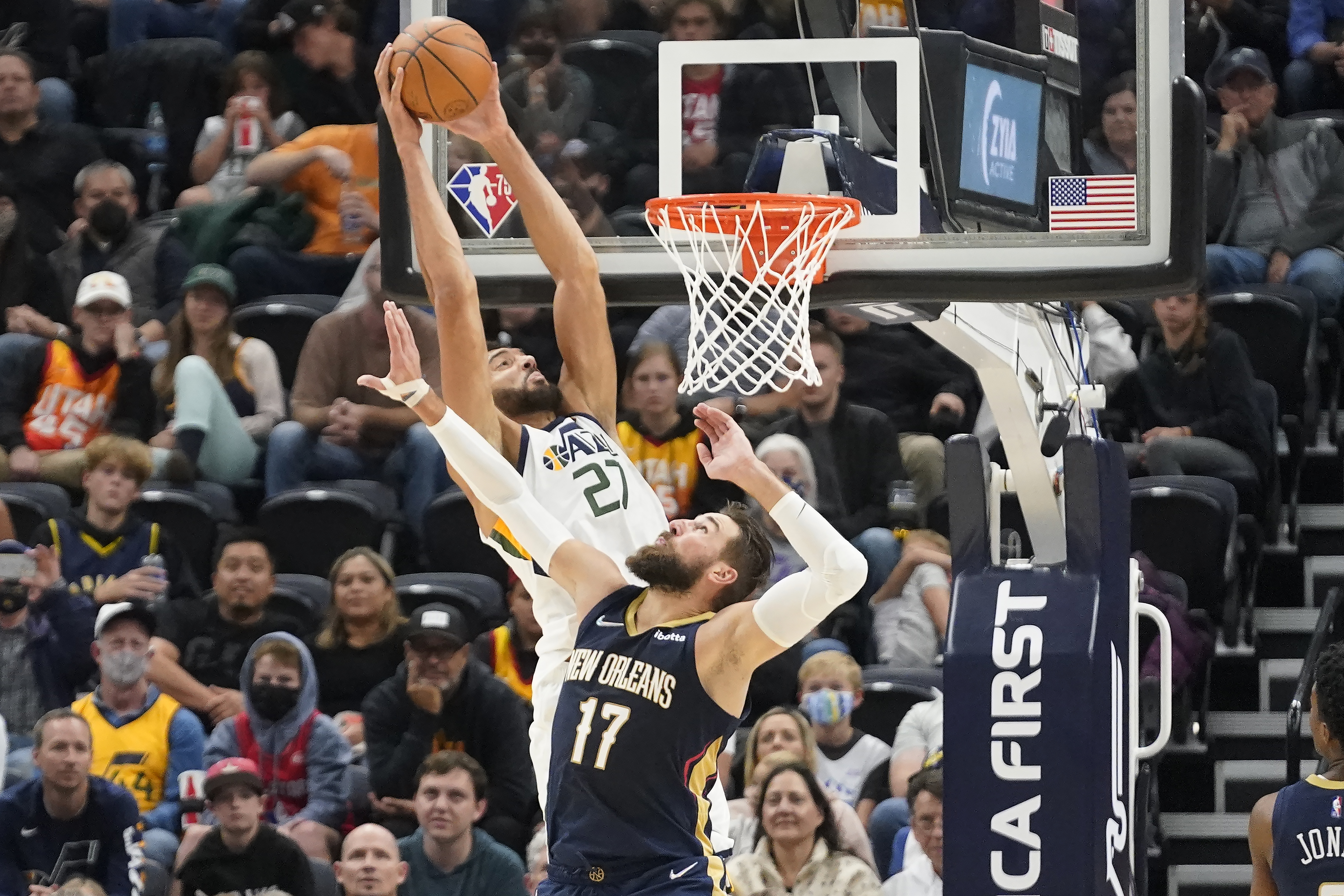 Utah Jazz center Rudy Gobert (27) dunks against New Orleans Pelicans' Jonas Valanciunas in the first half of a preseason NBA basketball game Monday, Oct. 11, 2021, in Salt Lake City. 