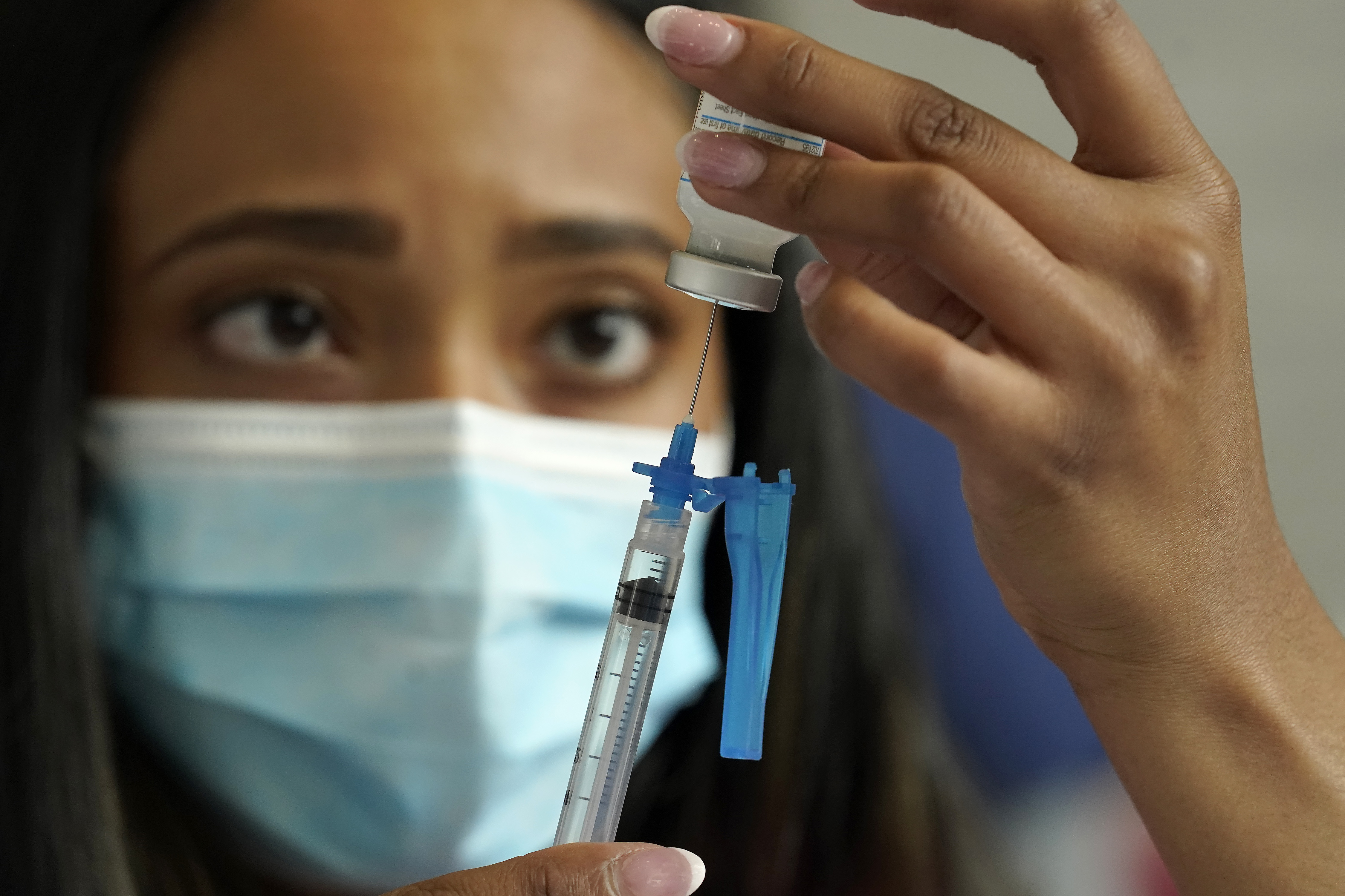 A licensed practical nurse draws a Moderna COVID-19 vaccine into a syringe at a mass vaccination clinic at Gillette Stadium in Foxborough, Massachusetts, May 19. Scientists at the Food and Drug Administration said on Tuesday that Moderna had not met all of the agency's criteria to support the use of booster doses of its COVID-19 vaccine, possibly because the efficacy of the shot's first two doses has remained strong.