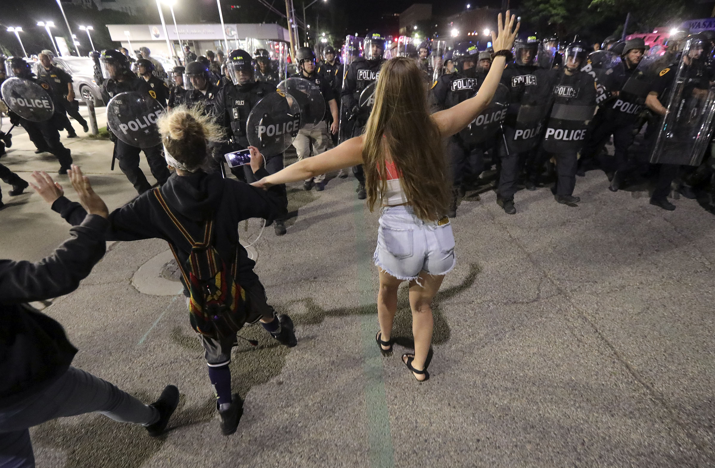 Police push protesters back as they violate curfew to protest the death of George Floyd in Salt Lake City on Saturday, May 30, 2020. More than a year later, over a dozen people who claim their constitutional rights were violated at the protest when Salt Lake City issued an emergency curfew have field a lawsuit against the city.
