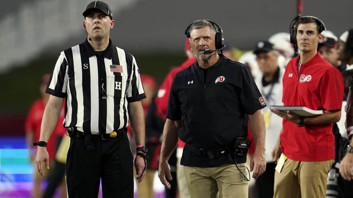 Utah head coach Kyle Whittingham stands next to a referee during the first half of an NCAA college football game against Southern California Saturday, Oct. 9, 2021, in Los Angeles.