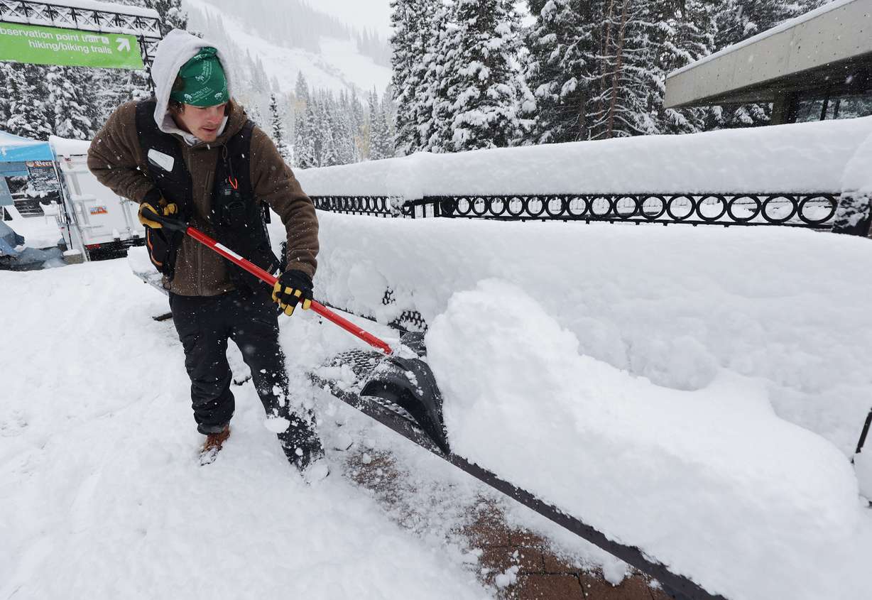 Rob Steiner clears snow from a bench at Snowbird on Tuesday, Oct. 12, 2021.